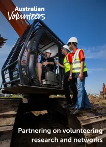 The cover page of the linked document. It includes the Australian Volunteers logo, and the title of the document: 'Partnering on volunteering research and networks'. The background image is of two men wearing safety helmets and vests, talking to a third man sitting inside a large digger.