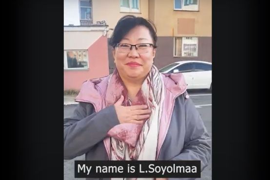 A person smiling and holding a hand to their chest. Text at the bottom of the screen reads: 'My name is L. Soyolmaa'